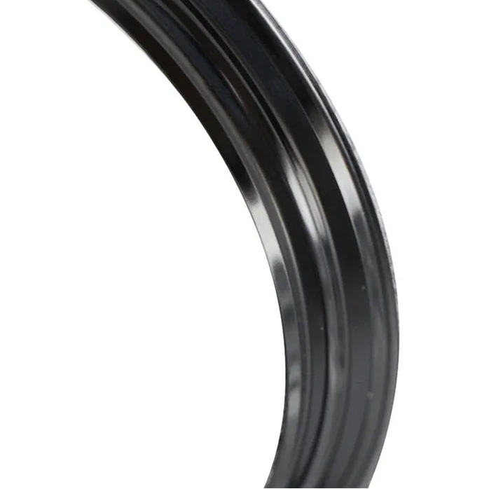 Close-up of a black metal ring on a white background.